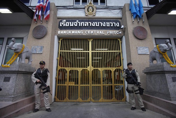 Guards stand holding weapons at Bangkwang Central Prison where suspected Russian arms smuggler Viktor Bout is being held in Nonthaburi Province